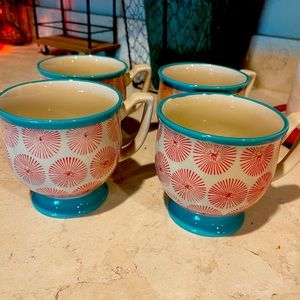 Set of 4 Pioneer Woman pedestal coffee mugs.
